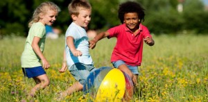 kids-chase-ball-in-summer-612x300